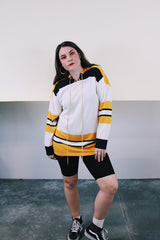 Men's vintage 1960's GC Knitting, Made in Canada label long sleeve cotton material white, yellow, and black hockey jersey with tie front neckline.