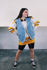 Women's or men's vintage 1970's Levi's label sleeveless light wash denim vest with cream shearling interior. Popper buttons and front pockets. Orange Levi's tab label.