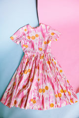 short sleeve midi length 1960's dress in white with pink and orange print