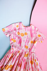 short sleeve midi length 1960's dress in white with pink and orange print