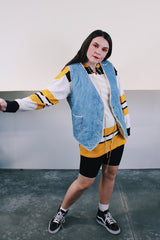 Women's or men's vintage 1970's Levi's label sleeveless light wash denim vest with cream shearling interior. Popper buttons and front pockets. Orange Levi's tab label.