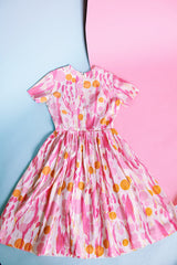 short sleeve midi length 1960's dress in white with pink and orange print
