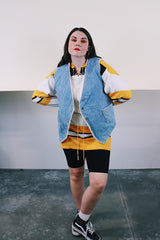 Women's or men's vintage 1970's Levi's label sleeveless light wash denim vest with cream shearling interior. Popper buttons and front pockets. Orange Levi's tab label.