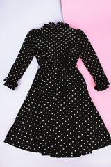 long sleeve knee length black dress with polka dots ruffle neckline and cuffs vintage 1970's