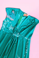 sleeveless maxi length turquoise dress with floral and bird print around hem vintage 1970's