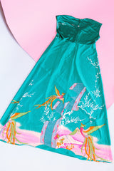 sleeveless maxi length turquoise dress with floral and bird print around hem vintage 1970's