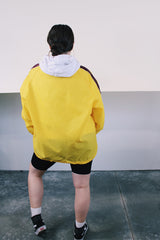 Women's or mens' vintage 1970's Swingster, World of Wearables label long sleeve yellow lightweight windbreaker with popper buttons and a maroon stripe on each arm. Schlitz patch on left chest