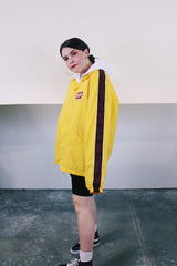 Women's or mens' vintage 1970's Swingster, World of Wearables label long sleeve yellow lightweight windbreaker with popper buttons and a maroon stripe on each arm. Schlitz patch on left chest