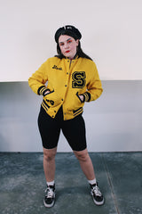 Women's vintage 1979 Nelson's Jackets, Portland, Oregon label long sleeve yellow and black wool letterman jacket. Popper buttons, patches, fully lined, knit ribbed trim.