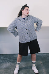 Women's vintage 1960's Pendelton label wool button up lightweight plaid jacket with big shell buttons up the front. Cream, navy, tan, and blue. Has pockets and shoulder pads.