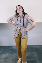 Men's vintage 1970's Towncraft JCPenney label short sleeve button up shirt with dagger collar. White with maroon, yellow, and grey vertical stripes in polyester and nylon material.