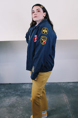 Men's vintage 1980's Lacy Sportswear label long sleeve zip up sportswear windbreaker jacket in navy blue cotton with patches sewn on all over.