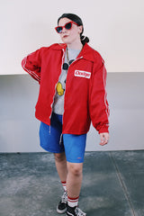 Men's vintage 1980's Horizon Sportswear Inc. label long sleeve red nylon zip up windbreaker with Dodge patch on chest and braided trim on arms.