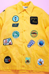 long sleeve yellow nylon windbreaker with patches all over vintage 1960's