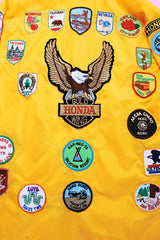 long sleeve yellow nylon windbreaker with patches all over vintage 1960's
