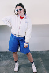 Women's or men's vintage 1960's Holloway "One shell of a jacket!", Made in USA label long sleeve white nylon zip up windbreaker with navy and red striped details.