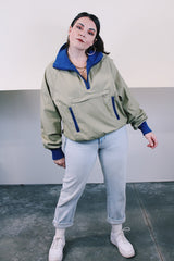 Women's or men's vintage 1970's Woolrich long sleeve pullover tan and blue polyester windbreaker with cotton ribbed knit trim.