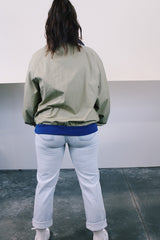 Women's or men's vintage 1970's Woolrich long sleeve pullover tan and blue polyester windbreaker with cotton ribbed knit trim.