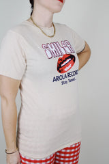 short sleeve light tan cotton t-shirt with Smiler Ariola Records graphic on the front 1970's