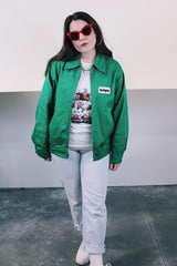 Women's or men's vintage 1970's K-Brand label long sleeve vibrant green zip up station jacket in lightweight cotton with patch on chest.
