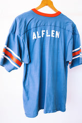 short sleeve blue t-shirt with red and white stripes on arm graphic on front and back vintage 1970's