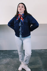 Women's or men's vintage 1970's long sleeve navy blue lightweight polyester button up jacket with chest pockets, dagger collar, and light blue stitching.