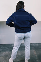 Women's or men's vintage 1970's long sleeve navy blue lightweight polyester button up jacket with chest pockets, dagger collar, and light blue stitching.