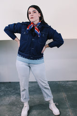 Women's or men's vintage 1970's long sleeve navy blue lightweight polyester button up jacket with chest pockets, dagger collar, and light blue stitching.