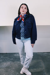 Women's or men's vintage 1970's long sleeve navy blue lightweight polyester button up jacket with chest pockets, dagger collar, and light blue stitching.