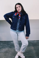 Women's or men's vintage 1970's long sleeve navy blue lightweight polyester button up jacket with chest pockets, dagger collar, and light blue stitching.