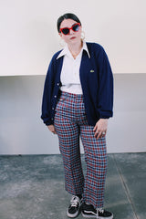 Men's or women's vintage 1980's IZOD Lacoste label long sleeve navy blue acrylic button up cardigan with ribbed hem and cuffs and V shaped neckline.