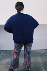 Men's or women's vintage 1980's IZOD Lacoste label long sleeve navy blue acrylic button up cardigan with ribbed hem and cuffs and V shaped neckline.