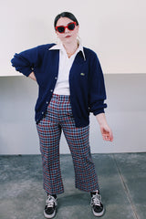 Men's or women's vintage 1980's IZOD Lacoste label long sleeve navy blue acrylic button up cardigan with ribbed hem and cuffs and V shaped neckline.