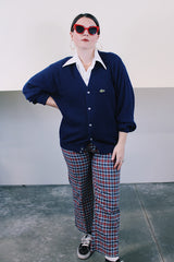 Men's or women's vintage 1980's IZOD Lacoste label long sleeve navy blue acrylic button up cardigan with ribbed hem and cuffs and V shaped neckline.