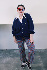 Men's or women's vintage 1980's IZOD Lacoste label long sleeve navy blue acrylic button up cardigan with ribbed hem and cuffs and V shaped neckline.