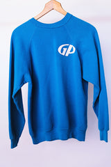 long sleeve blue crew neck sweater with cavemen graphic vintage 1970's