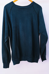 long sleeve navy crew neck sweater with yellow felt UCL logo on front vintage 1970's