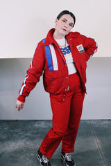 Men's vintage 1970's Swingster, World of Wearables label long sleeve red zip up jacket in nylon material with fleece and quilted liner. Popper buttons, pockets, and Cessna patch.