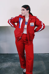 Men's vintage 1970's Swingster, World of Wearables label long sleeve red zip up jacket in nylon material with fleece and quilted liner. Popper buttons, pockets, and Cessna patch.