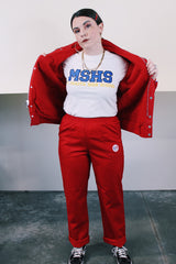 Men's vintage 1970's Swingster, World of Wearables label long sleeve red zip up jacket in nylon material with fleece and quilted liner. Popper buttons, pockets, and Cessna patch.