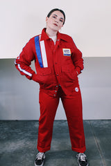 Men's vintage 1970's Swingster, World of Wearables label long sleeve red zip up jacket in nylon material with fleece and quilted liner. Popper buttons, pockets, and Cessna patch.