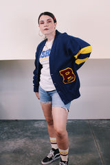 Women's or men's vintage 1970's Dehen Knitting Co., Portland, Oregon label long sleeve navy blue button up cardigan with maroon and yellow patch and stripes in acrylic material.