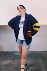 Women's or men's vintage 1970's Dehen Knitting Co., Portland, Oregon label long sleeve navy blue button up cardigan with maroon and yellow patch and stripes in acrylic material.