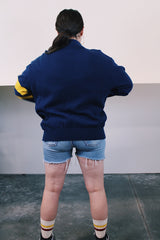 Women's or men's vintage 1970's Dehen Knitting Co., Portland, Oregon label long sleeve navy blue button up cardigan with maroon and yellow patch and stripes in acrylic material.