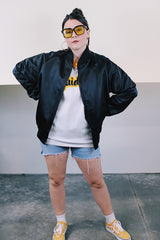 Women's or men's vintage 1988 long sleeve black shiny stain polyester bomber jacket with side pockets. Has 88' Olympics Seoul Korea embroidered on the back with Olympics logo.