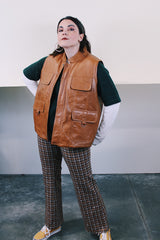 Women's or men's vintage 1980's Top label sleeveless light brown camel colored faux leather vest with four pockets, popper buttons, and zipper.