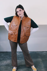 Women's or men's vintage 1980's Top label sleeveless light brown camel colored faux leather vest with four pockets, popper buttons, and zipper.
