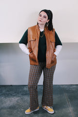 Women's or men's vintage 1980's Top label sleeveless light brown camel colored faux leather vest with four pockets, popper buttons, and zipper.