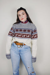 vintage 1980's High Sierra Mervyn's long sleeve cable knit pullover print with a reindeer print across the chest. White with grey, maroon, and navy print.