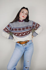 vintage 1980's High Sierra Mervyn's long sleeve cable knit pullover print with a reindeer print across the chest. White with grey, maroon, and navy print.